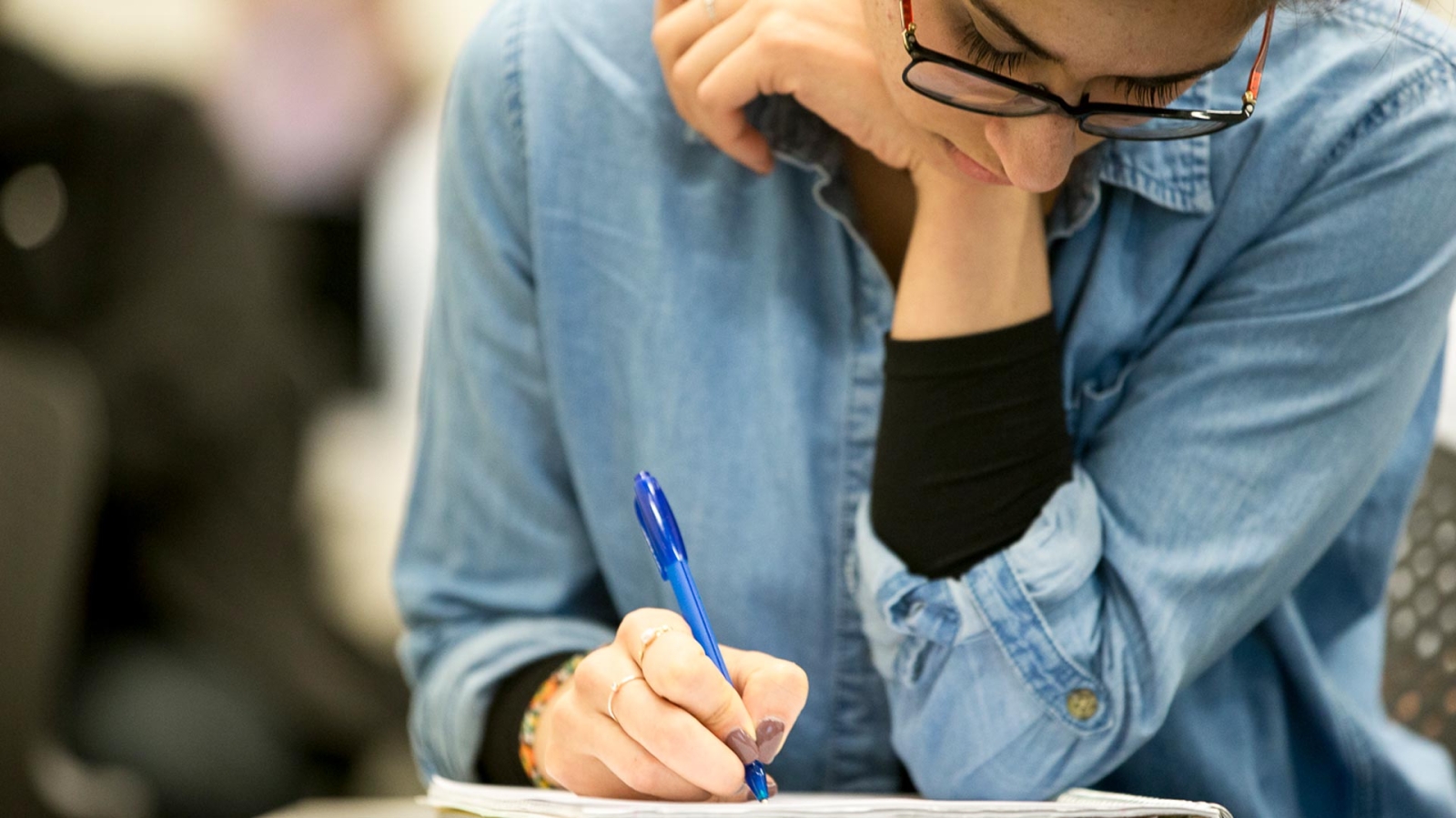 Student writing in a notebook
