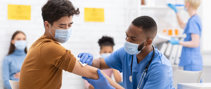 Doctor sanitizing patient arm for vaccination